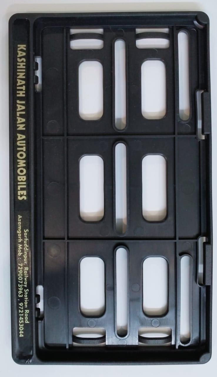 Number plate frame close-up — dealer name embossed